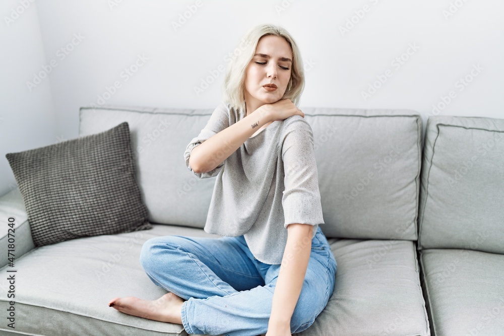Young caucasian woman have back pain at home