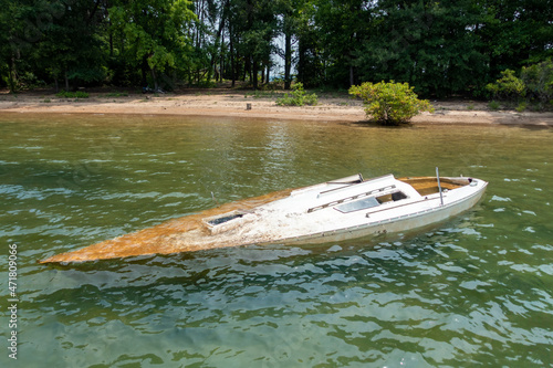 Obraz na plátne dirty sunken boat floating in the lake