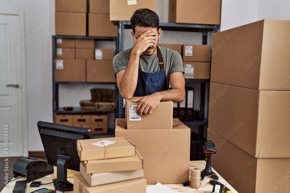 Young hispanic man business worker stressed working at storehouse Young hispanic man business worker stressed working at storehouse