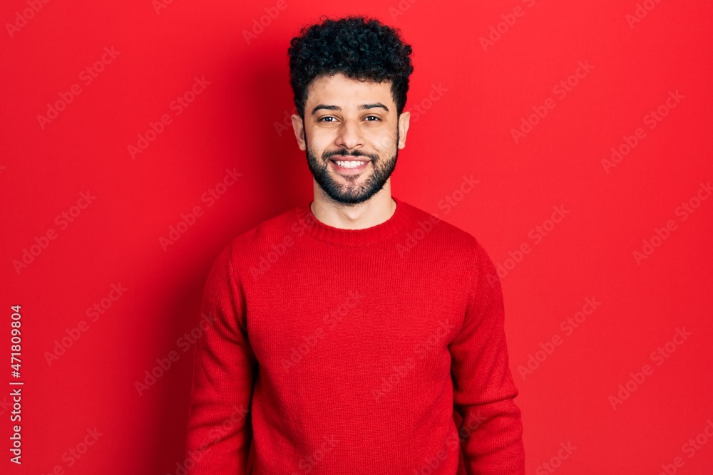 Young arab man with beard wearing casual red sweater with a happy and cool smile on face. lucky person. Young arab man with beard wearing casual red sweater with a happy and cool smile on face. lucky person.