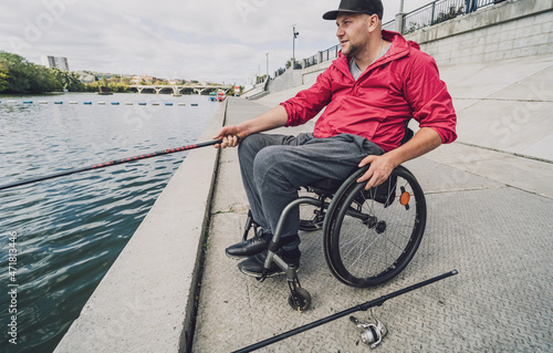 Person with a physical disability in a wheelchair fishing from fishing pier.