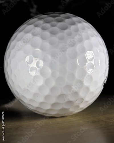 Golf ball on a wooden surface