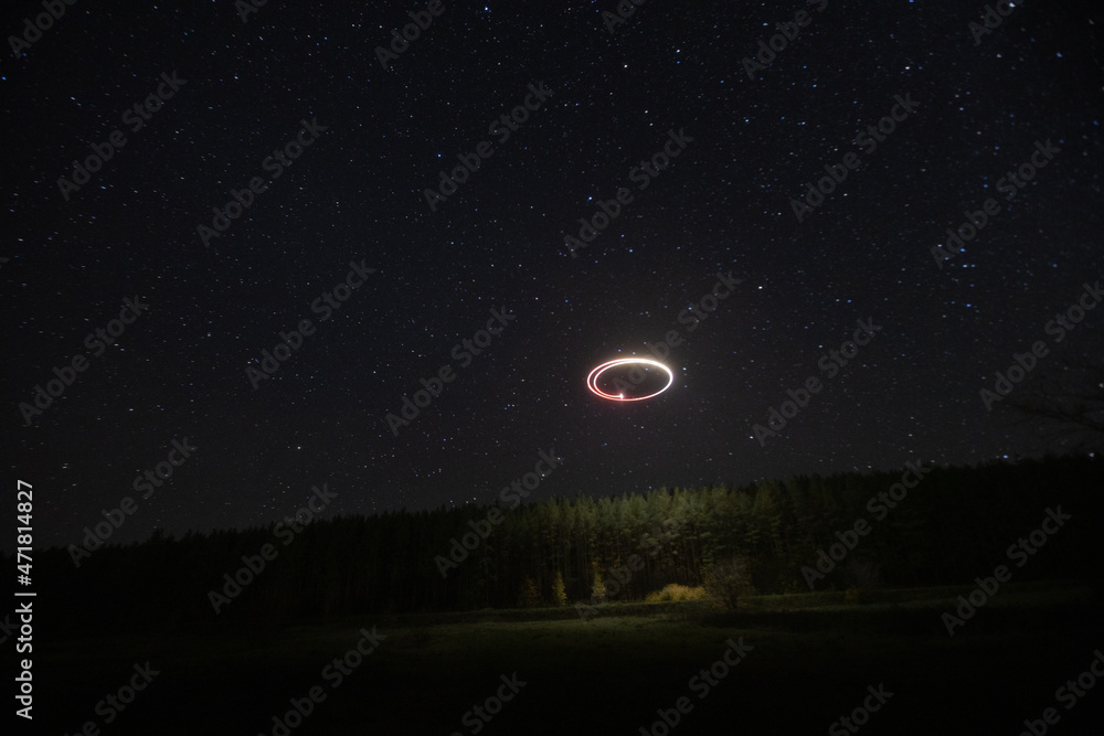 flying a quadcopter at night in the starry sky