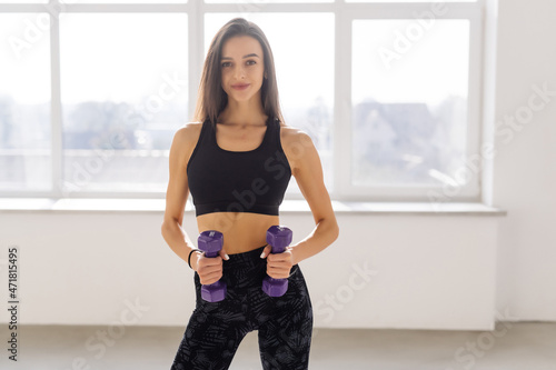 fitness and home concept. Fit young sporty woman with light dumbbells Free Download fitness and home concept. Fit young sporty woman with light dumbbells - GFXLoad