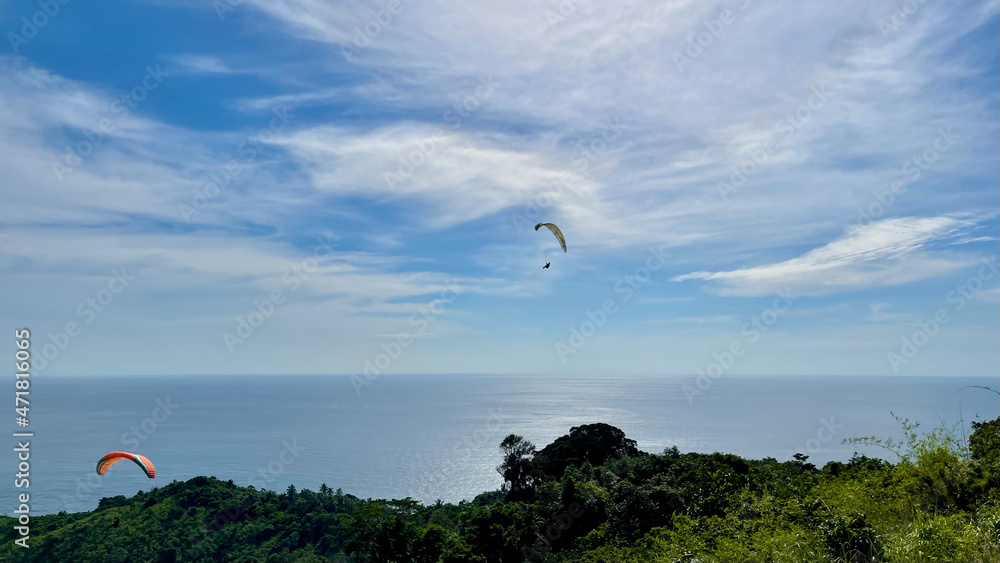 BASE jumping, tropical island. Bright colors. Orange and yellow