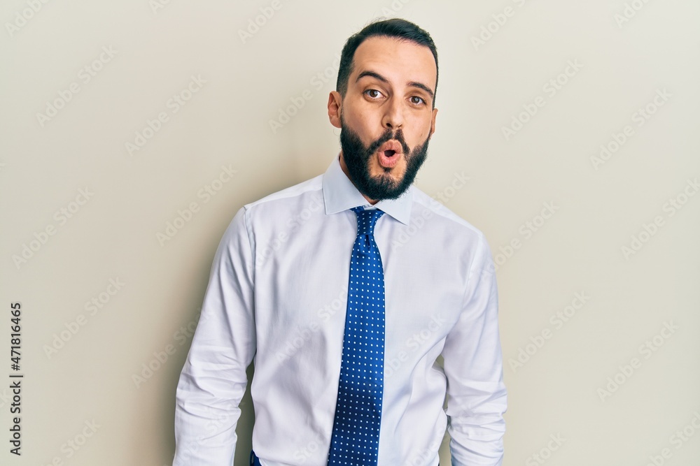 Young man with beard wearing business tie afraid and shocked with surprise expression, fear and excited face. Young man with beard wearing business tie afraid and shocked with surprise expression, fear and excited face.