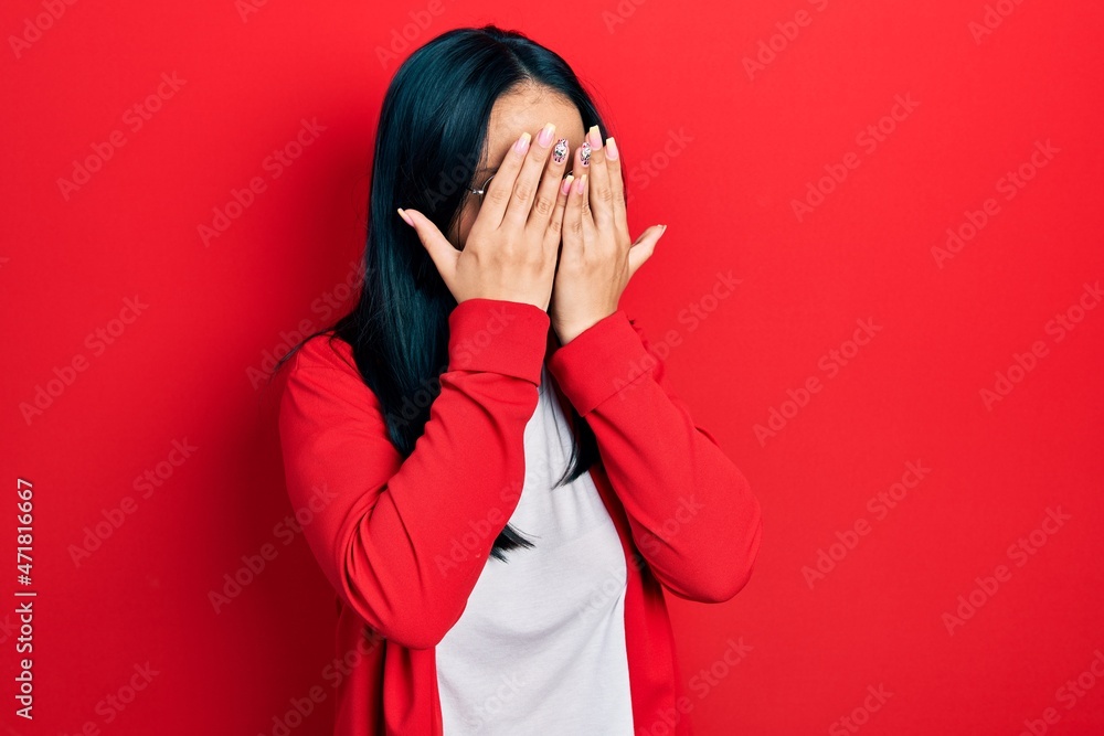 Beautiful hispanic woman with nose piercing wearing casual look and glasses with sad expression covering face with hands while crying. depression concept. Beautiful hispanic woman with nose piercing wearing casual look and glasses with sad expression covering face with hands while crying. depression concept.