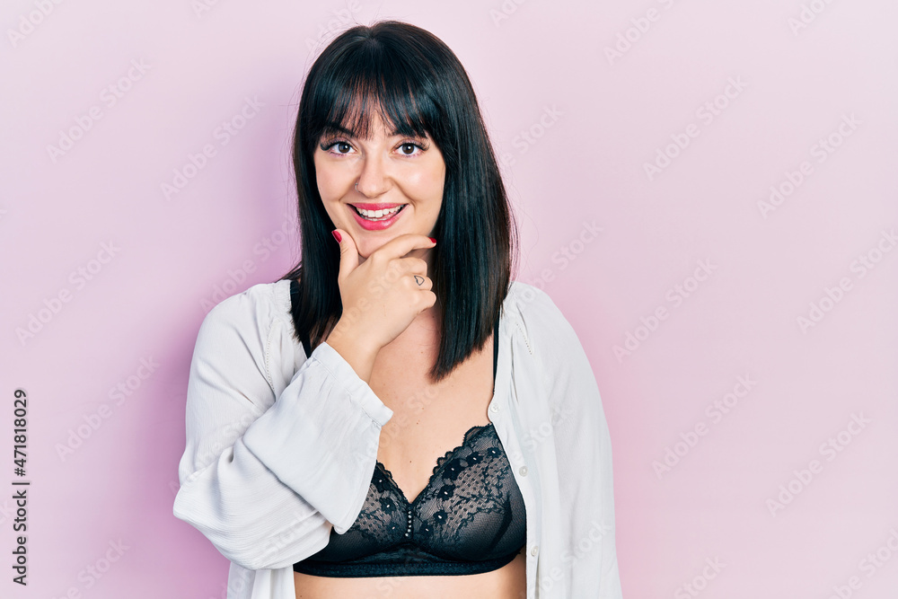 Young hispanic woman wearing lingerie looking confident at the camera smiling with crossed arms and hand raised on chin. thinking positive. Young hispanic woman wearing lingerie looking confident at the camera smiling with crossed arms and hand raised on chin. thinking positive.