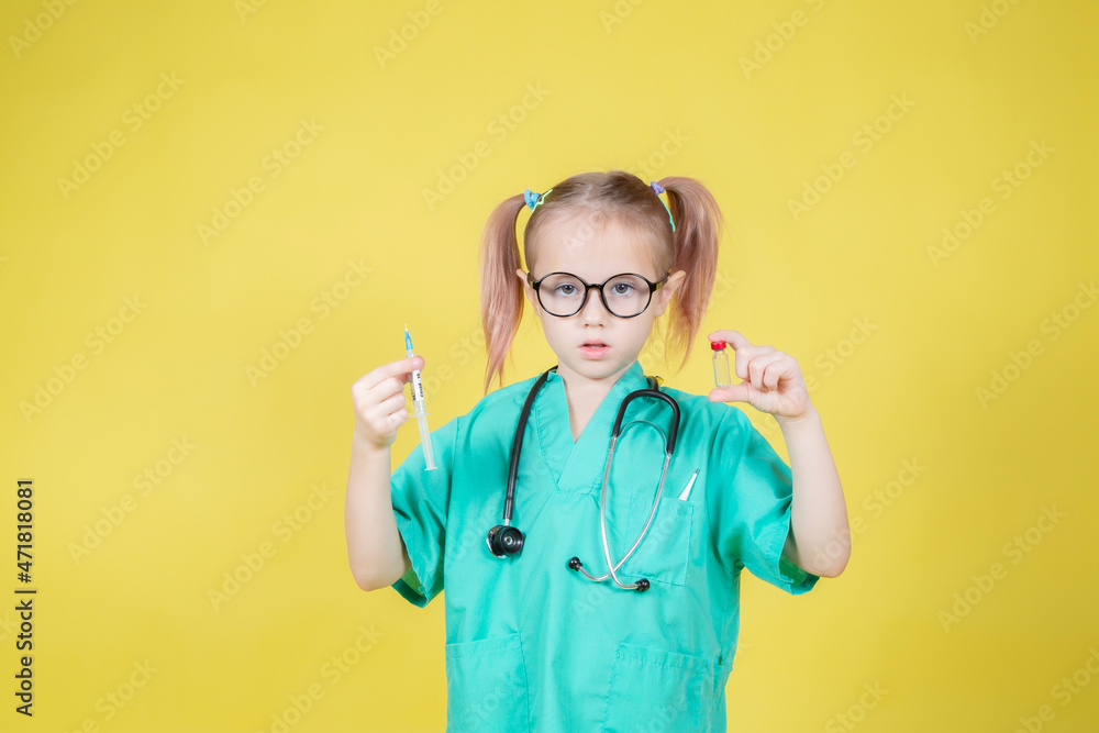 Portrait of little girl dressed in doctors coat with syringe and medicine bottle Portrait of little girl dressed in doctors coat with syringe and medicine bottle