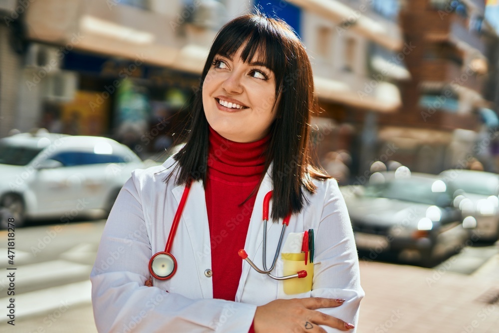 Young brunette woman wearing doctor uniform and stethoscope at the city
