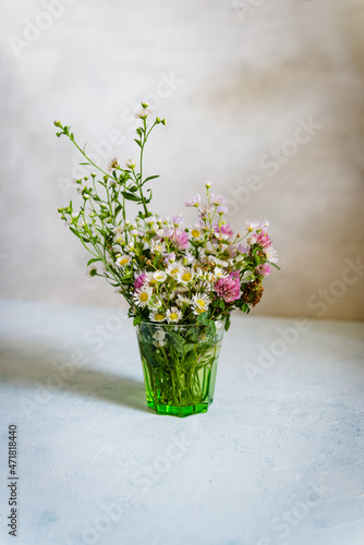 Bouquet of wild natural flowers  selective focus. Wildflowers  in vase on vintage background