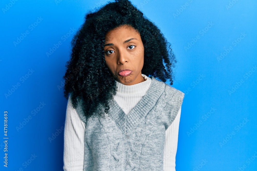 African american woman with afro hair wearing casual winter sweater depressed and worry for distress, crying angry and afraid. sad expression. African american woman with afro hair wearing casual winter sweater depressed and worry for distress, crying angry and afraid. sad expression.