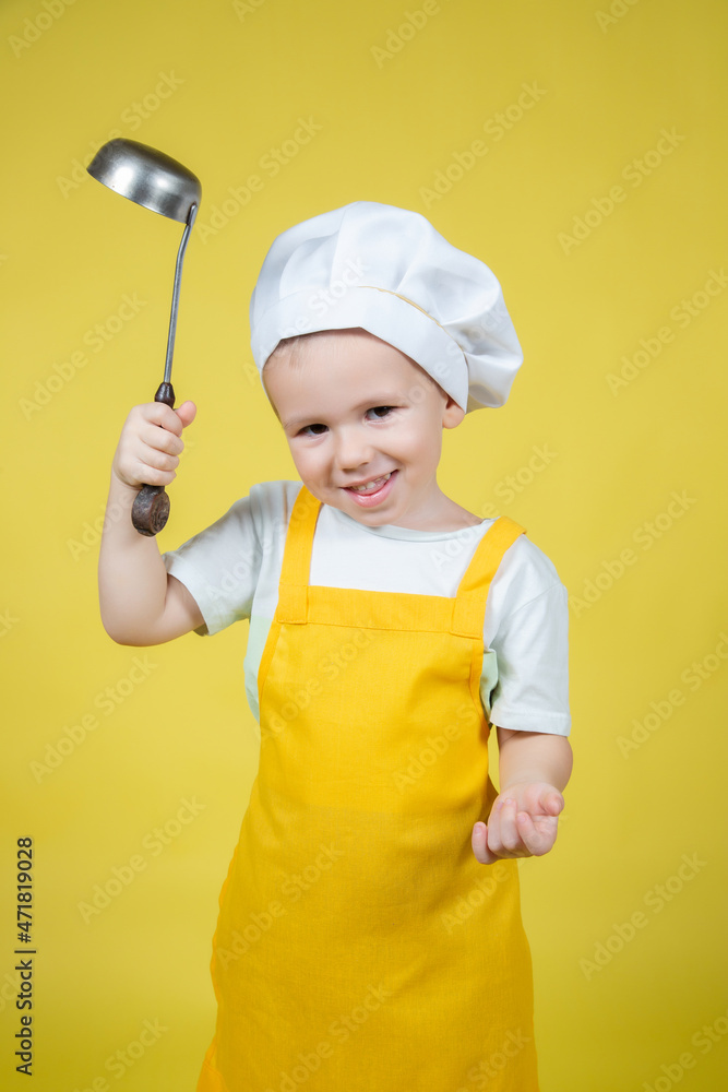 Little Boy playing chef, boy in apron and chef's hat emotionally posing Little Boy playing chef, boy in apron and chef's hat emotionally posing