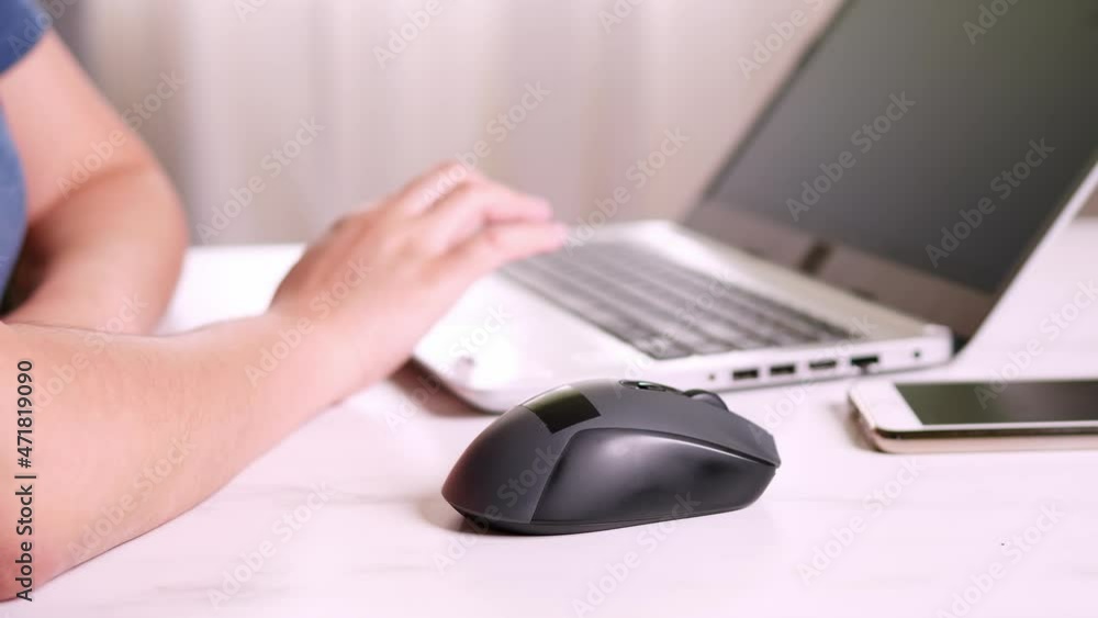 A woman works on a laptop while sitting at home. The concept of remote work during a pandemic A woman works on a laptop while sitting at home. The concept of remote work during a pandemic