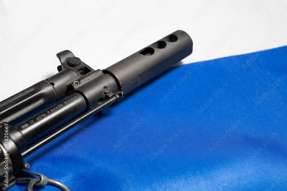 Closeup of the barrel and muzzle brake of a Russian made rifle on the Russian flag. Closeup of the barrel and muzzle brake of a Russian made rifle on the Russian flag.