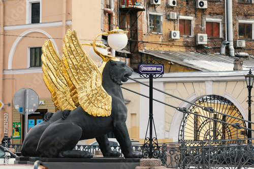 Saint Petersburg, Russia - March 2021: Sculptures of Griffin with golden wings on the Bank bridge