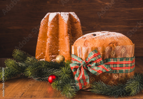 Pandoro and Panettone traditional Italian Christmas sweets on wooden background copy space. 