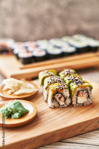  Wooden board of shrimp and cheese cream uramaki sushi on a wooden surface