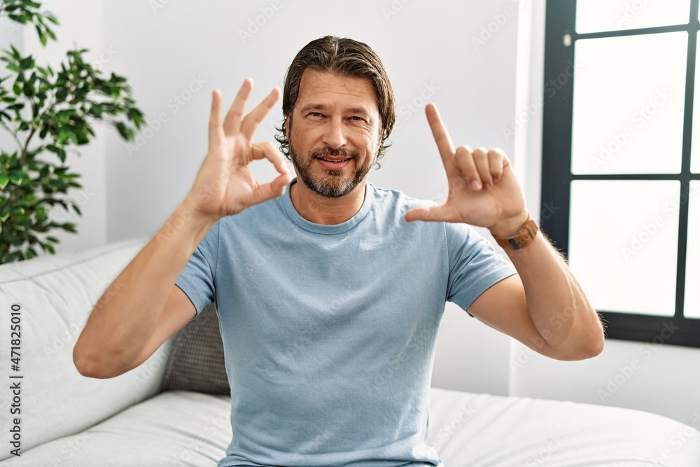 Middle age caucasian man smiling confident communicate with deaf sign language at home Middle age caucasian man smiling confident communicate with deaf sign language at home