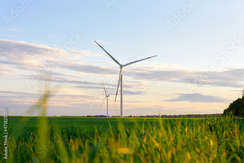 View on alternative energy windmills in a windpark in Ulyanovsk in front of a blue sky. Windmills for electric power production.