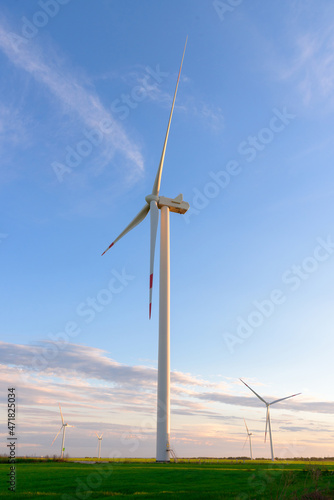 View on alternative energy windmills in a windpark in Ulyanovsk in front of a blue sky. Windmills for electric power production.