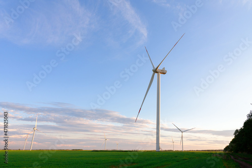 View on alternative energy windmills in a windpark in Ulyanovsk in front of a blue sky. Windmills for electric power production.