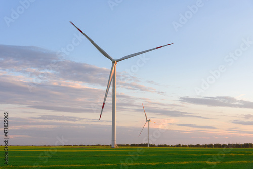 View on alternative energy windmills in a windpark in Ulyanovsk in front of a blue sky. Windmills for electric power production.