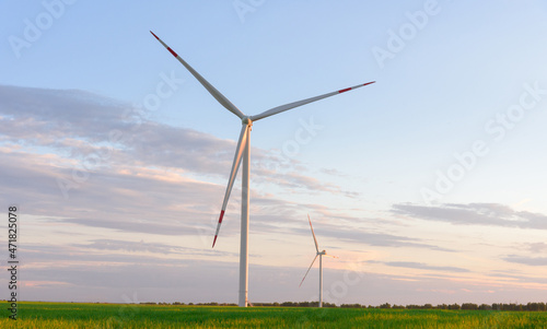 View on alternative energy windmills in a windpark in Ulyanovsk in front of a blue sky. Windmills for electric power production.