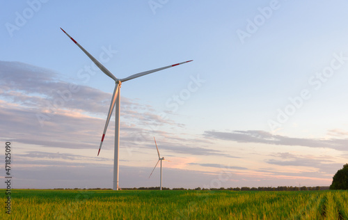 View on alternative energy windmills in a windpark in Ulyanovsk in front of a blue sky. Windmills for electric power production.