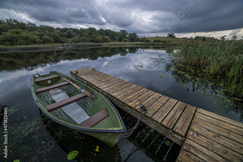 Картината върху платно A rowing boat tied up at a wooden jetty at Crom Estate, Upper Lough Erne