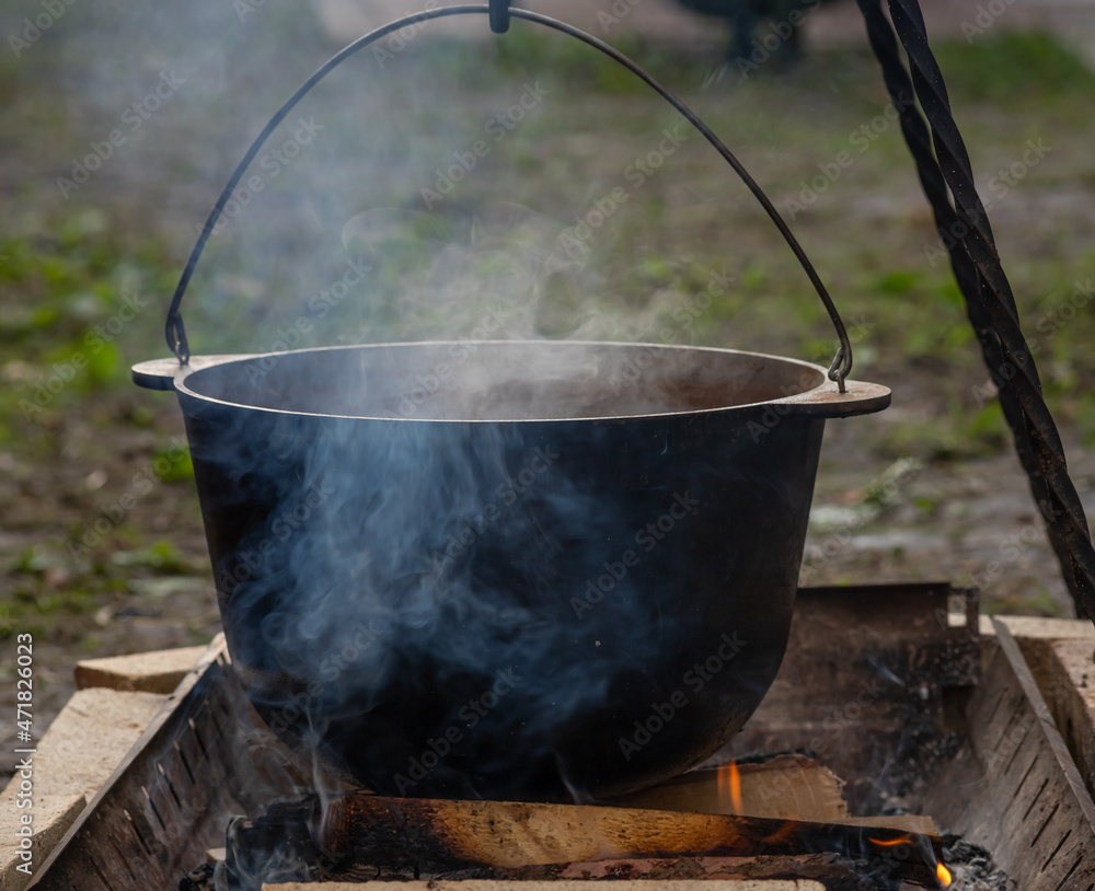 Hiking pot in the bonfire. Traveling in the mountains with tents