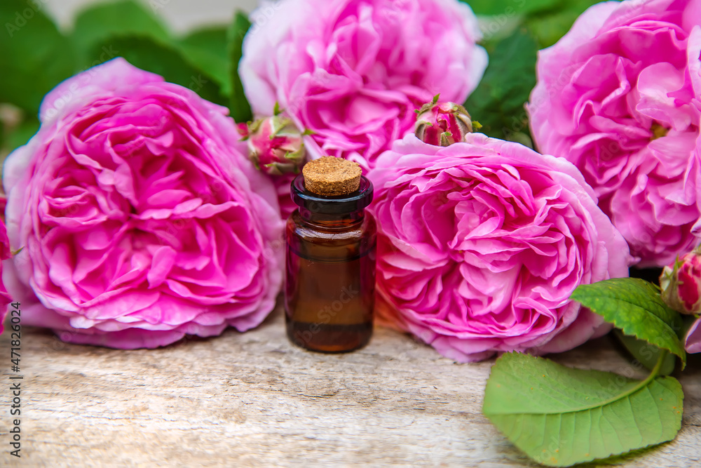 Rose essential oil in a small bottle. Selective focus. Rose essential oil in a small bottle. Selective focus.