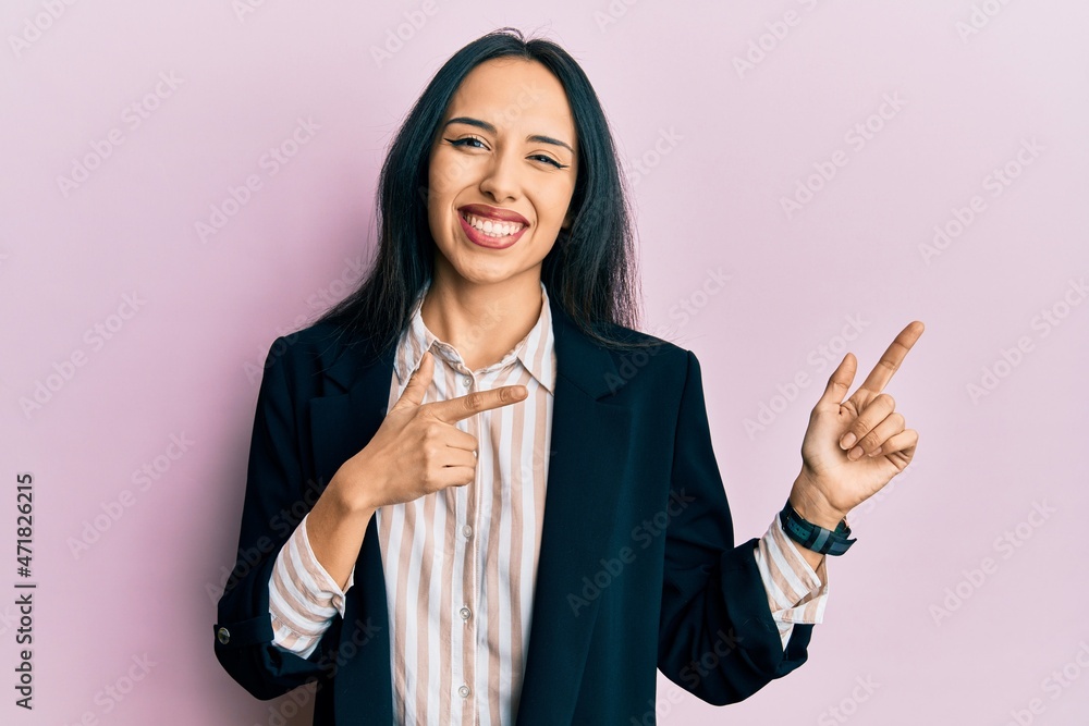 Young hispanic girl wearing business clothes smiling and looking at the camera pointing with two hands and fingers to the side. Young hispanic girl wearing business clothes smiling and looking at the camera pointing with two hands and fingers to the side.