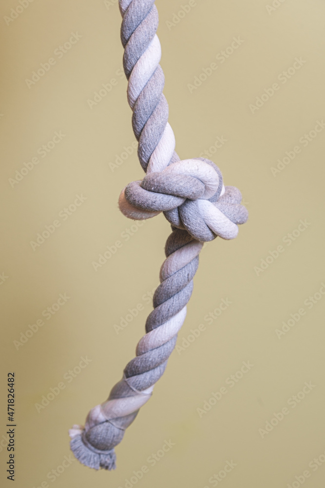 Vertical image of a thick twisted rope. Gymnastics sports equipment