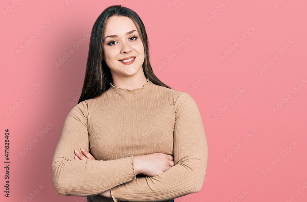 Young hispanic woman wearing casual clothes happy face smiling with crossed arms looking at the camera. positive person. Young hispanic woman wearing casual clothes happy face smiling with crossed arms looking at the camera. positive person.