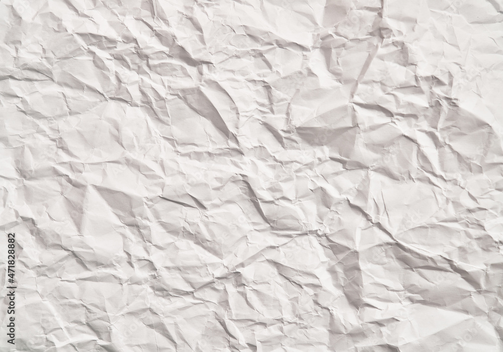 Fototapeta premium White crumpled paper texture with wrinkles. Damaged and torn sheet