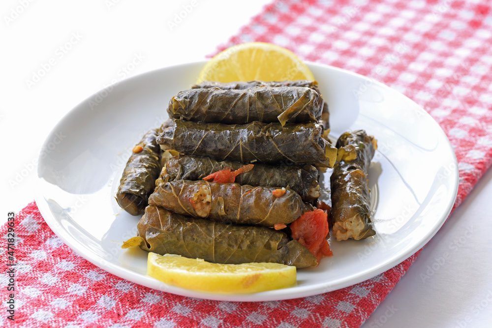 Delicious dolma (sarma) stuffed grape leaves rice, white yogurt sauce ...