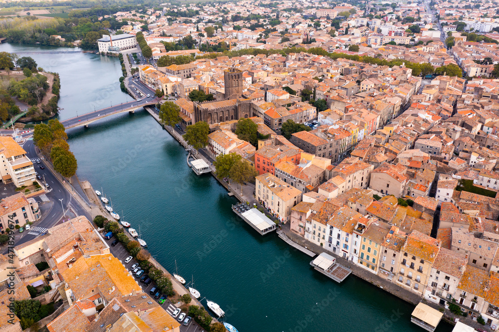 Townscape of Agde, south of France. Agde Cathedral and Herault River visible from above.