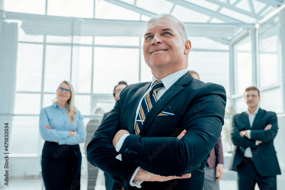 confident Mature businessman standing in the office confident Mature businessman standing in the office
