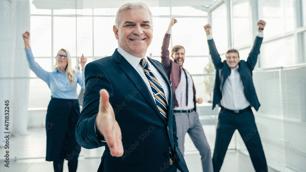 confident businessman holding out his hand for a handshake. confident businessman holding out his hand for a handshake.