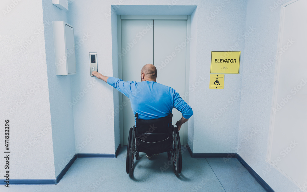 Person with a physical disability in a wheelchair using lift in building