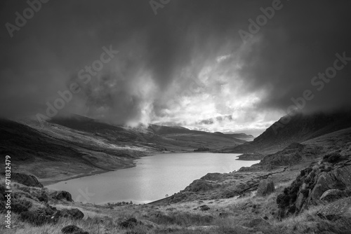 Black and white Epic early Autumn Fall landscape of view along Ogwen Valley in Snowdonia National Park under dramatic evening sky with copy space