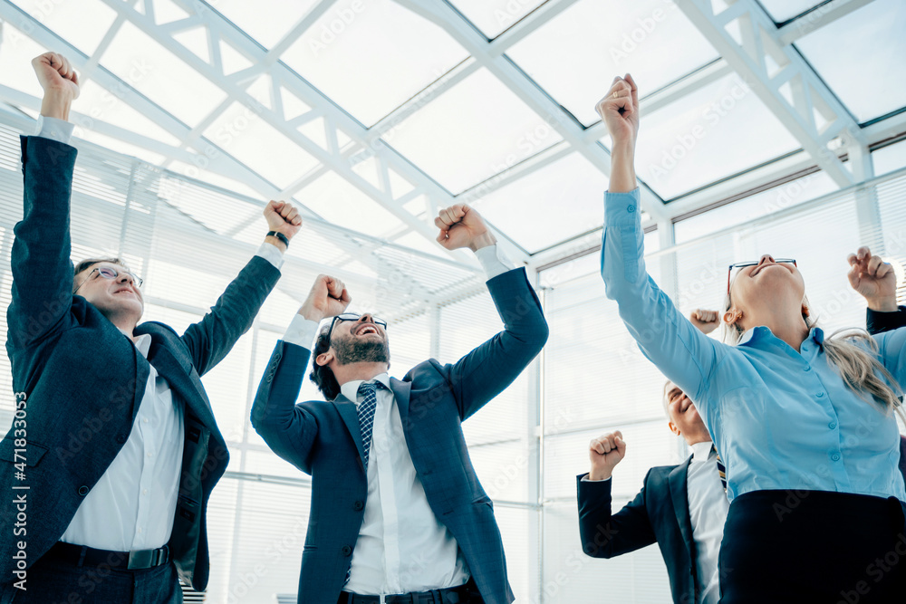 jubilant business woman standing in front of her colleagues jubilant business woman standing in front of her colleagues