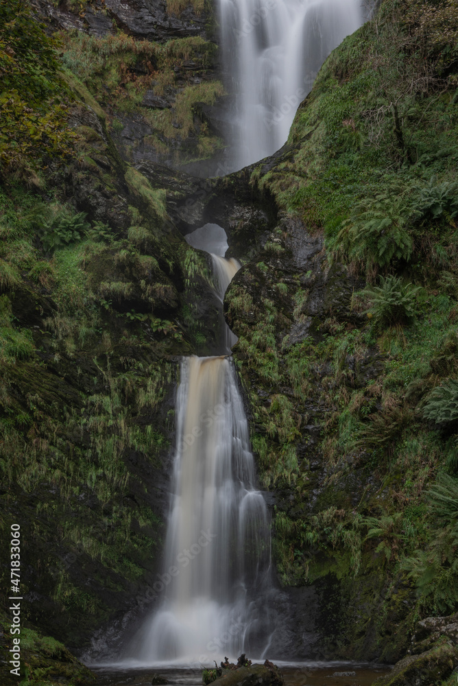 Stunning long exposure landscape early Autumn image of Pistyll Rhaeader waterfall in Wales, the tallest waterfall in UK