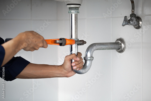 plumber at work in a bathroom, plumbing repair service, assemble and install concept.