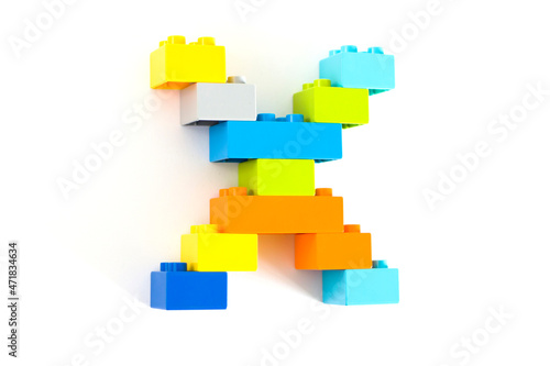 Colorful toy brick letter X