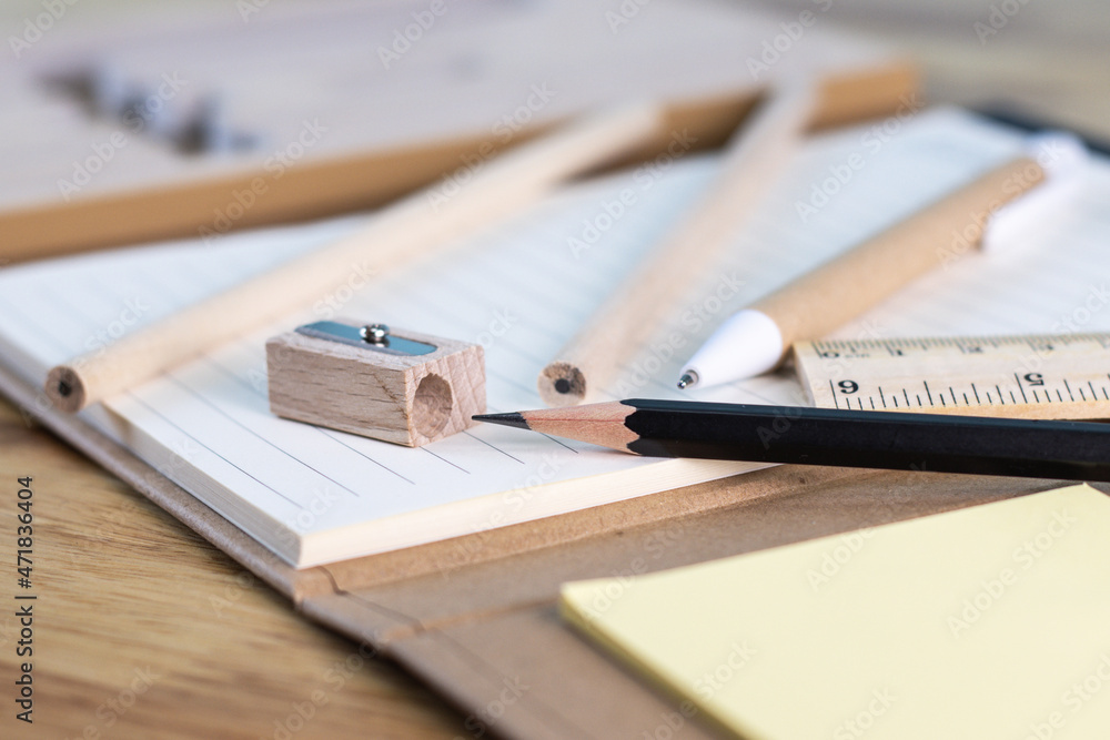 Fototapeta premium selective focus pencil for writing and paper book on wood table concept equipment office and school