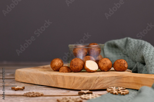 l German Christmas sweets called 'Marzipankartoffeln'. Round ball shaped almond paste pieces covered in cinnamon and cocoa powder