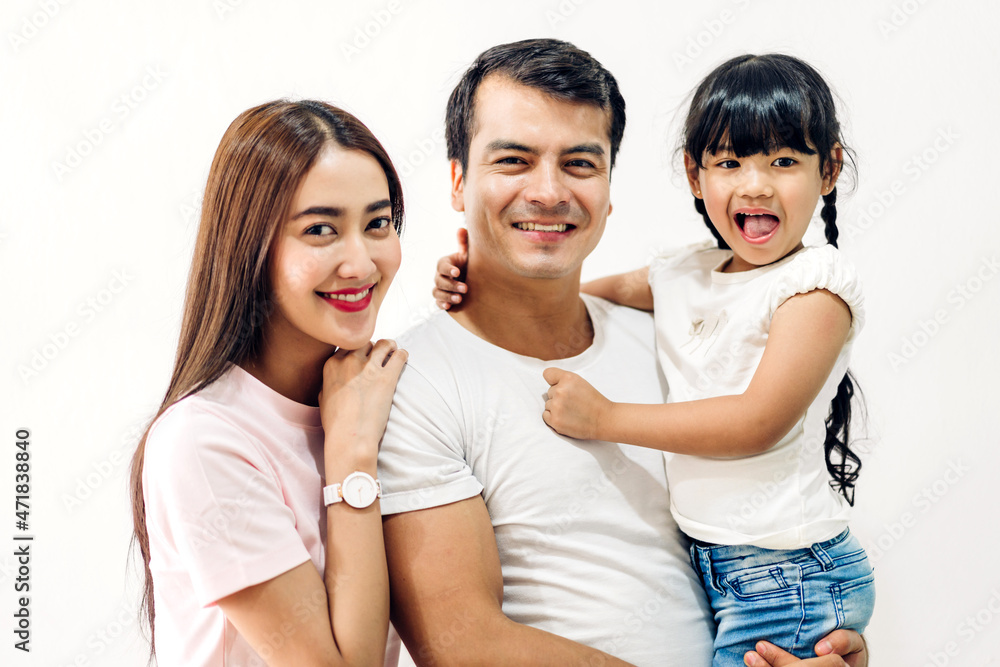 Portrait enjoy happy smiling love asian family father and mother with young parents little child asian girl daughter play ann look at camara in moments good time on wall background Portrait enjoy happy smiling love asian family father and mother with young parents little child asian girl daughter play ann look at camara in moments good time on wall background