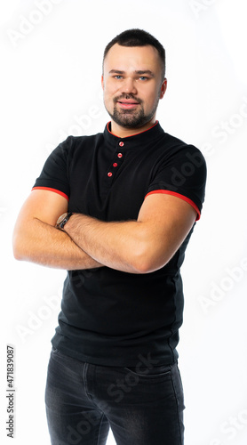 portrait of a man in a black t-shirt and jeans in the studio. pumped up Italian macho. isolated white background